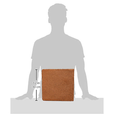Example of a coco coir block in front of a person's silhouette, showing the scale of the block. 