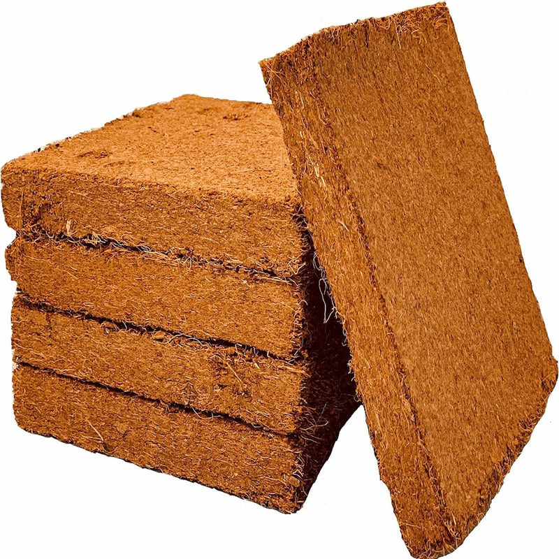 A stack of for coco coir bricks with a fifth brick leaning against the stack. 