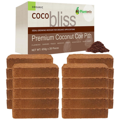 Four stacks of coco coir bricks in front of a premium coconut coir pith box. There is a loos pile of coco to show texture. 