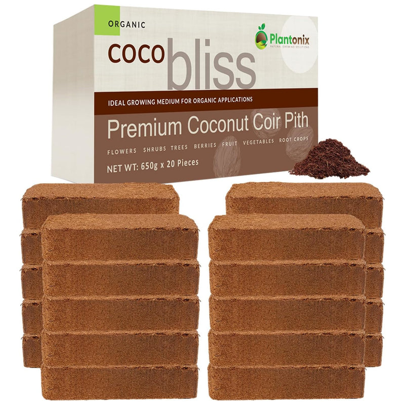 Four stacks of coco coir bricks in front of a premium coconut coir pith box. There is a loos pile of coco to show texture. 