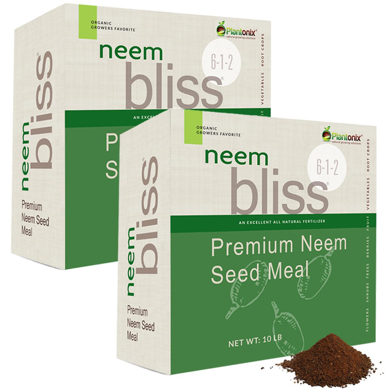  A loose pile of neem seed meal in front of two boxes of Premium Neem Seed Meal. 